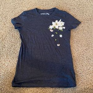 Black short sleeve tee. With a floral accent.